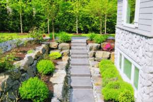 Landscaped garden pathway with stone steps and lush greenery outside a modern home