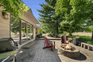 Backyard patio with fire pit surrounded by fire-safe landscaping and fire-resistant hardscaping.